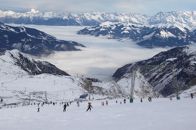 Image of skiers in an alpine ski resort on a snowy day