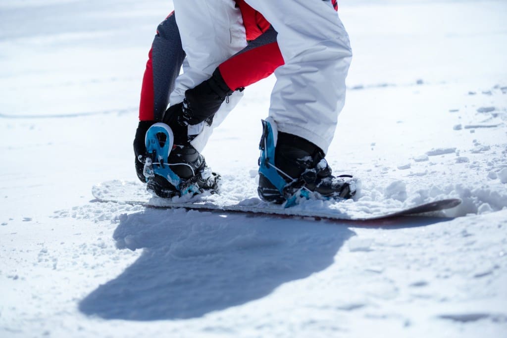 Snowboarder prepared for snowboarding,  sunny day on mountains