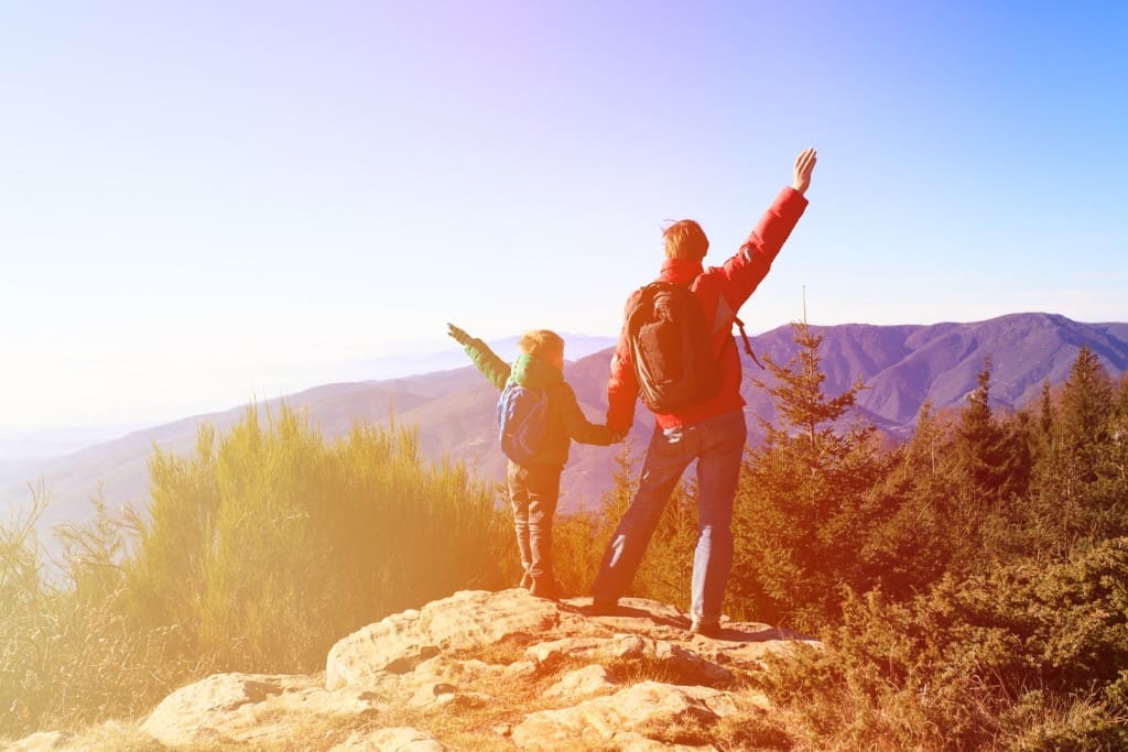 happy family hiking in scenic mountains