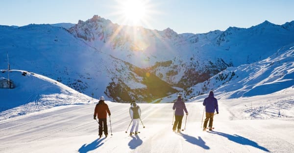 A group of skiers skiing down a mountain