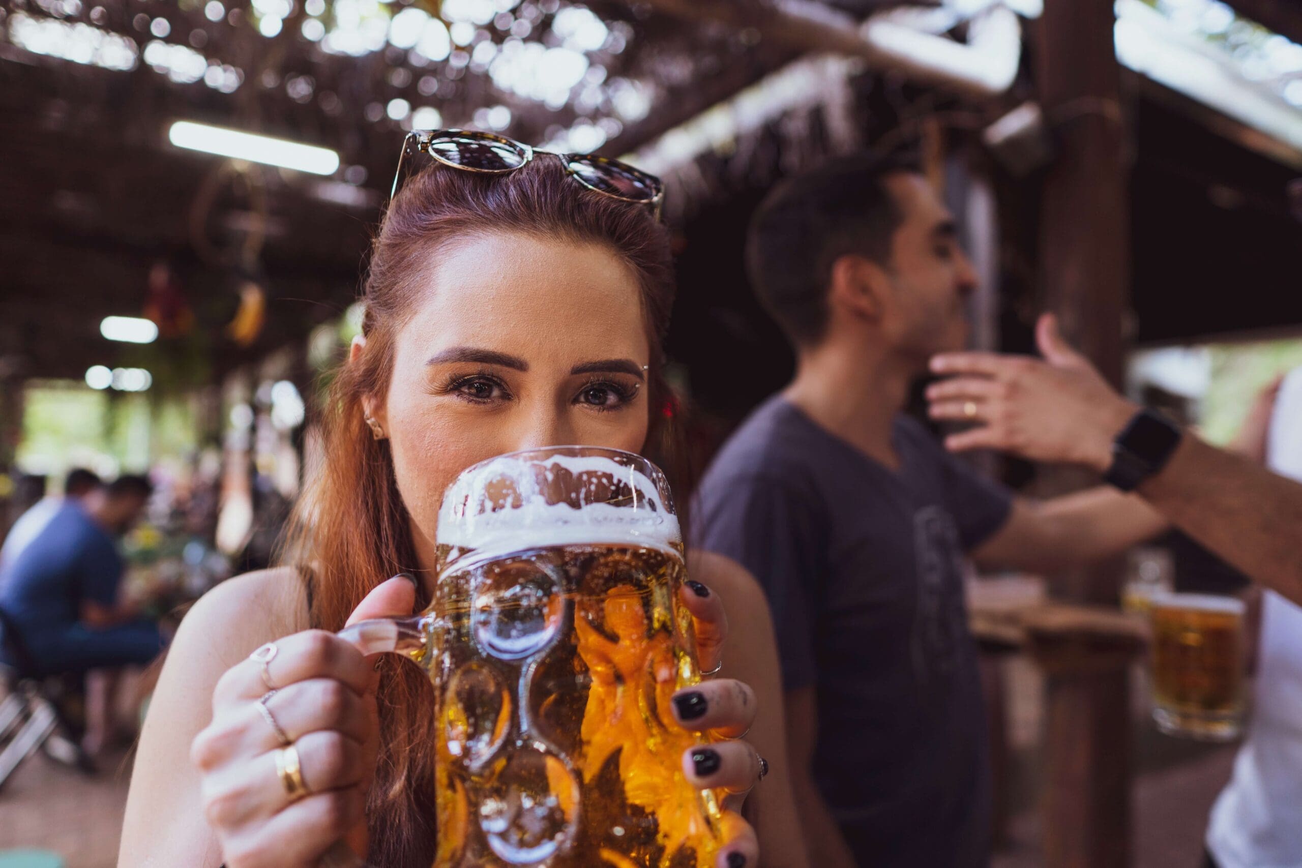 Girl drinking a large beer at a ski resort