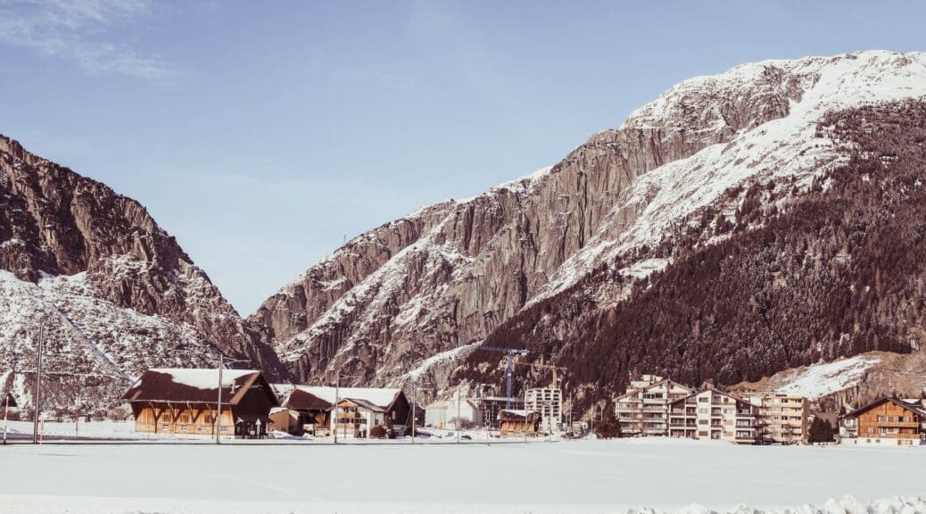 Houses near snowy mountains in Andermatt, Switzerland