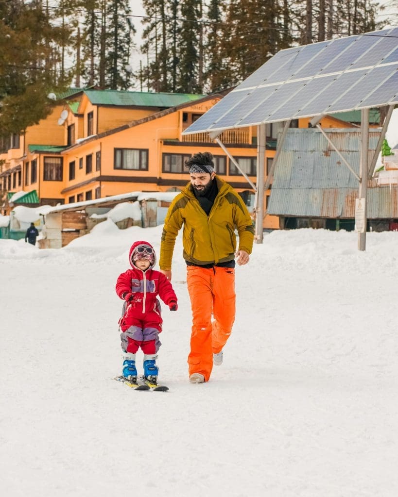 Father and child walking in ski resort