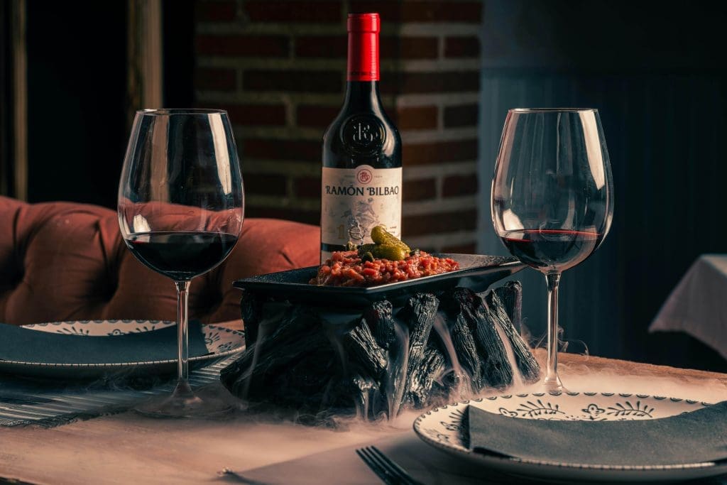 Tartare and red wine on a restaurant table