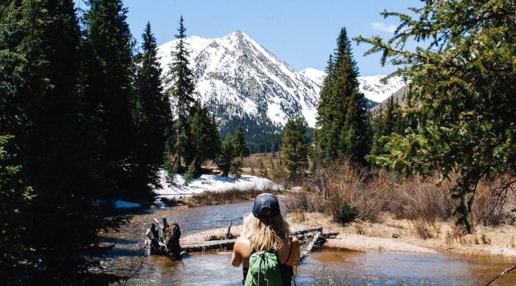 Female with backpack in Bulgaria with mountains in the background